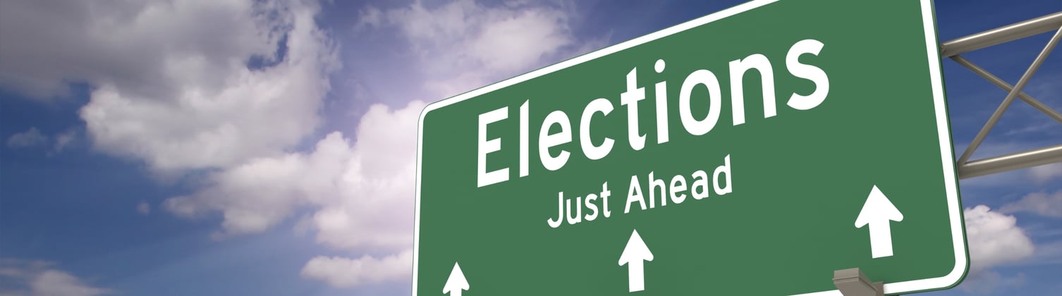 A green direction sign with an arrow pointing to the words 