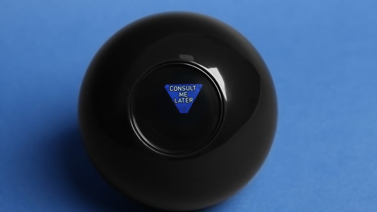 A magic 8 ball on a blue surface, with the message 