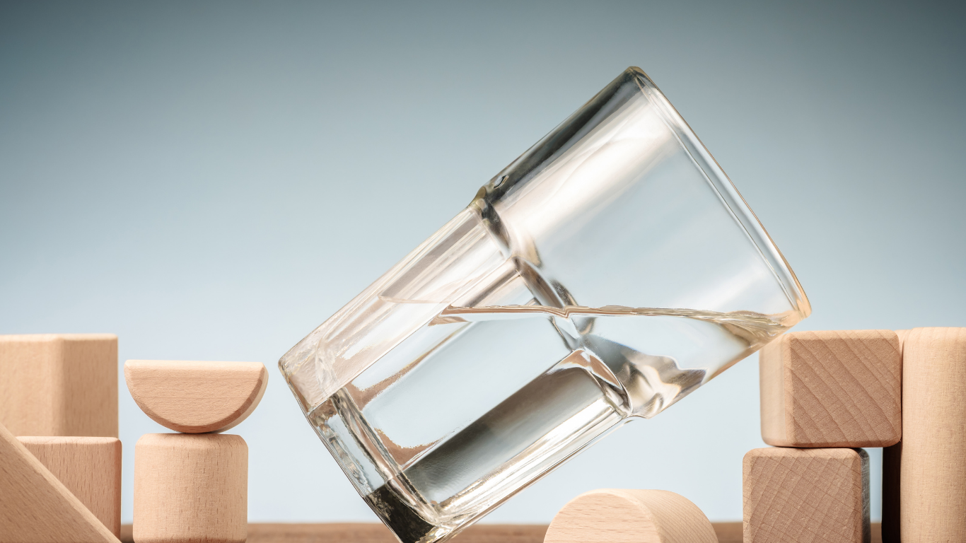 Glass filled with water, tilting.