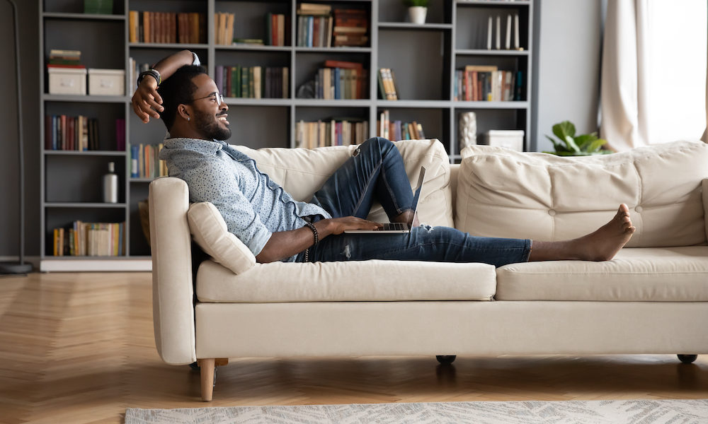 Millennial man on sofa at home