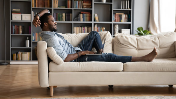 Millennial man on sofa at home